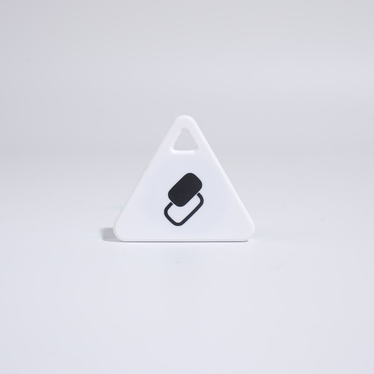 White triangular pet tracker tag with black symbol