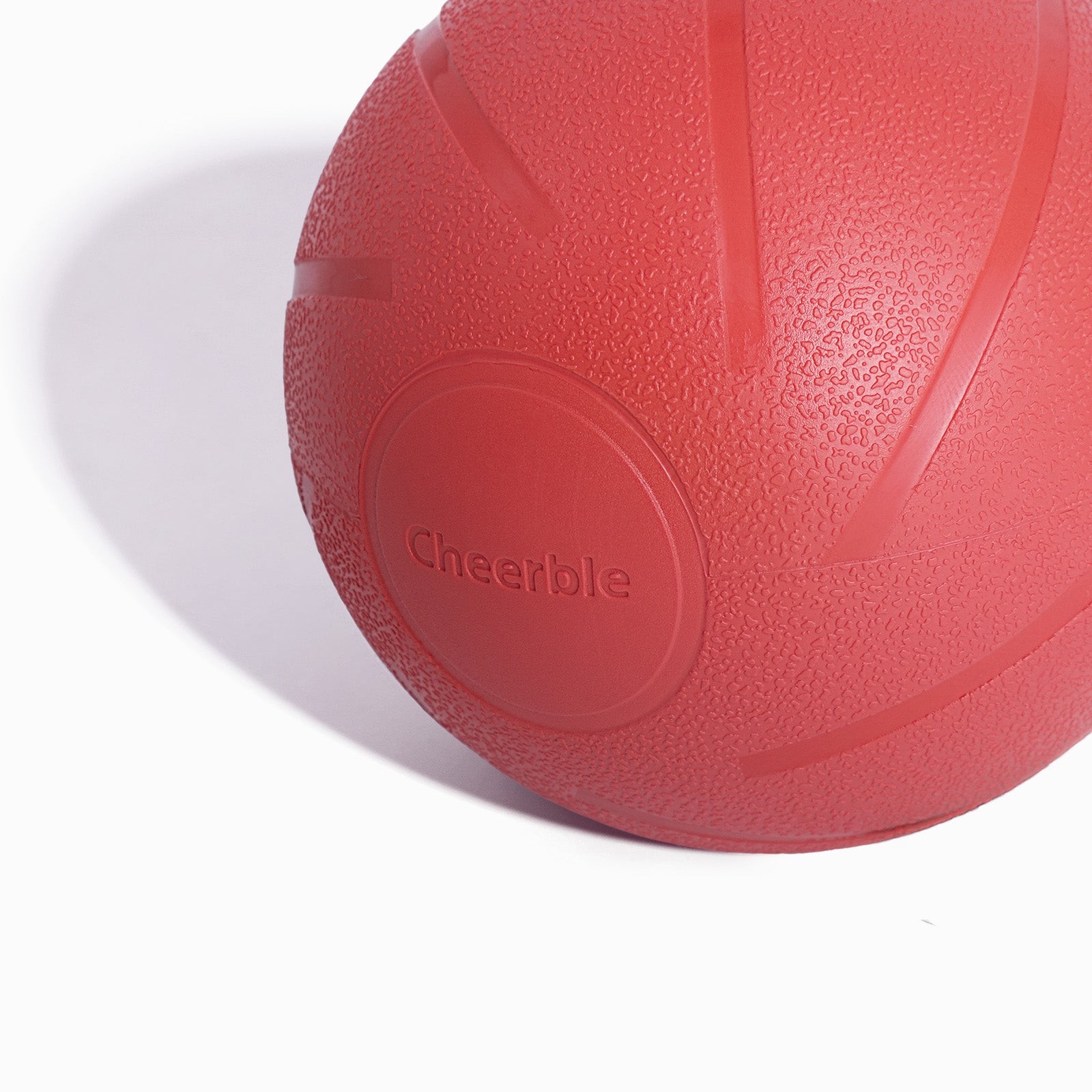 Close-up of red Wicked Ball PE dog toy with Cheerble logo