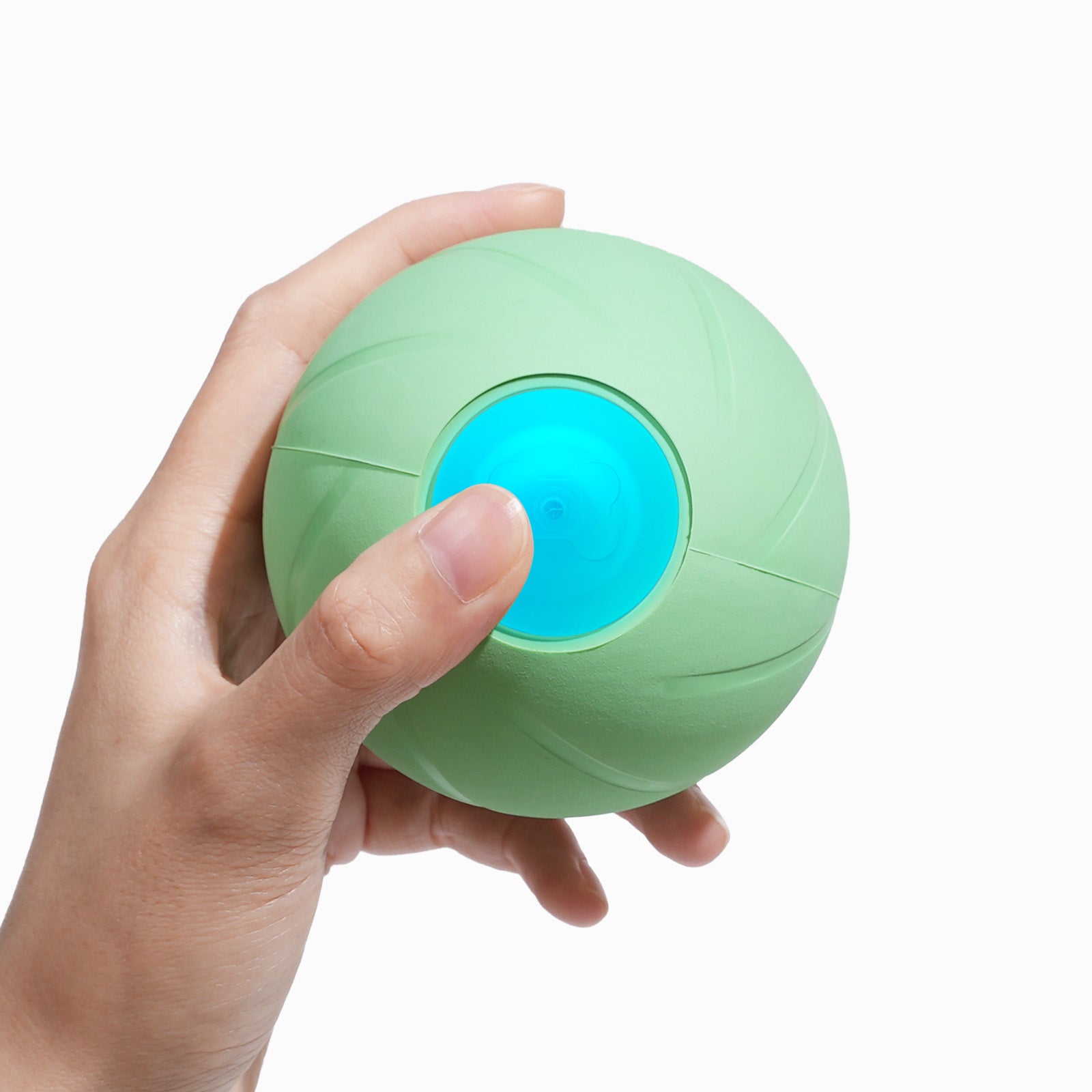 Hand holding a green Wicked Ball PE dog toy
