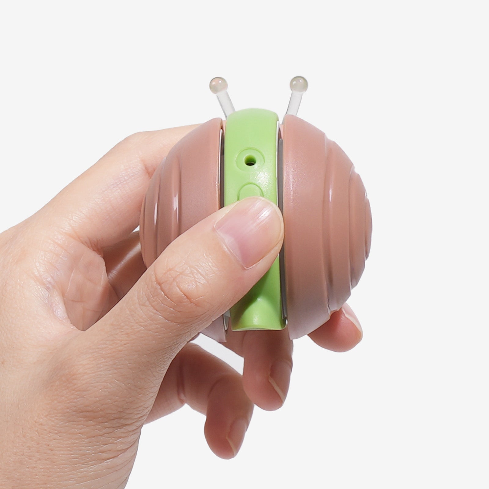 Hand holding Wicked Snail cat toy, close-up view